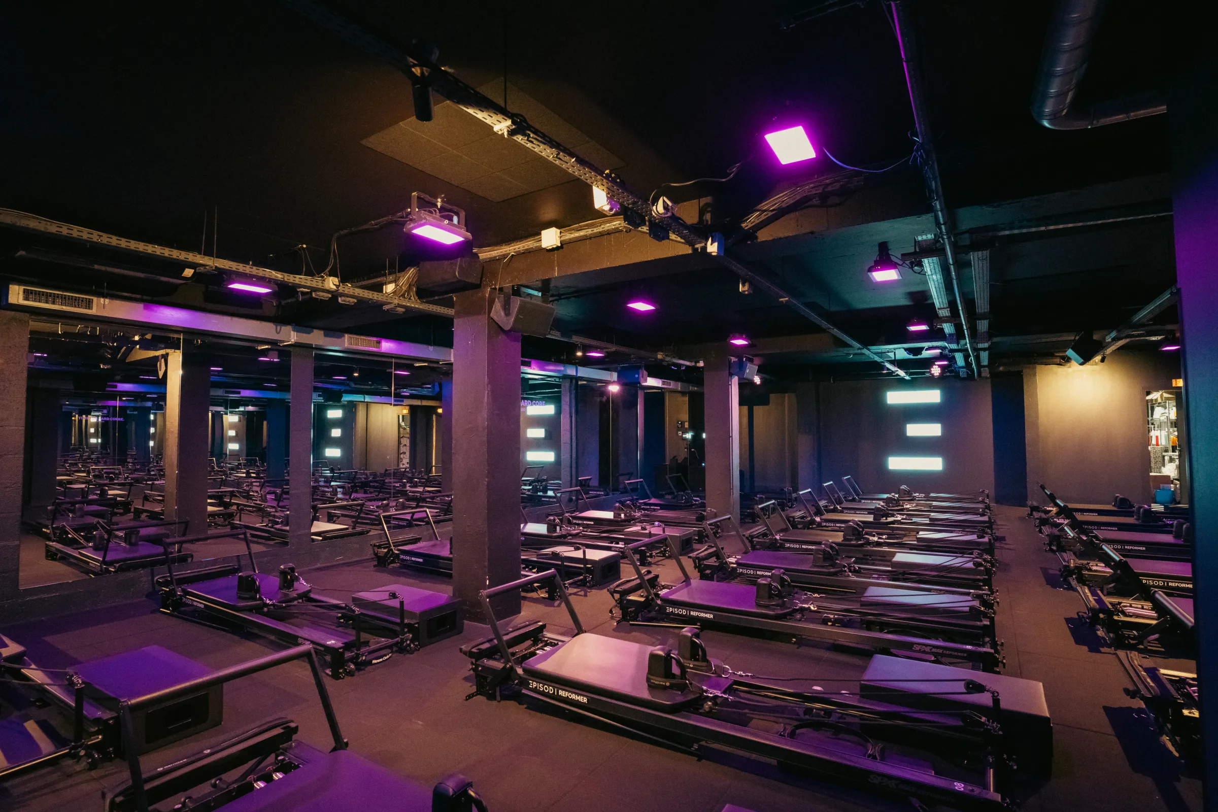 Episod Louvre, Paris : salle de reformers sous un éclairage violet, enceintes fixées aux poteaux